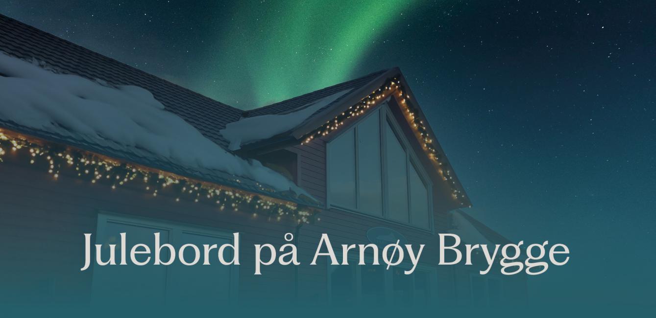 Julebord på Arnøy Brygge. Arnøy Brygge under nordlyset med snø på taket. 